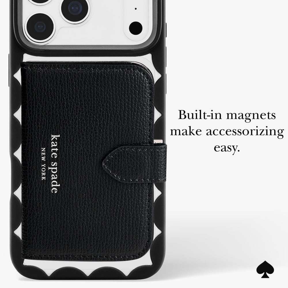 A black Kate Spade New York phone case with a built-in card holder and magnetic closure, shown on a white phone. The case features a textured black leather front pocket with the 'kate spade new york' logo, a black scalloped bumper, and white text on the right reading 'Built-in magnets make accessorizing easy.
#color_scallop black
