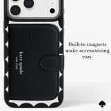 A black Kate Spade New York phone case with a built-in card holder and magnetic closure, shown on a white phone. The case features a textured black leather front pocket with the 'kate spade new york' logo, a black scalloped bumper, and white text on the right reading 'Built-in magnets make accessorizing easy.
#color_scallop black
