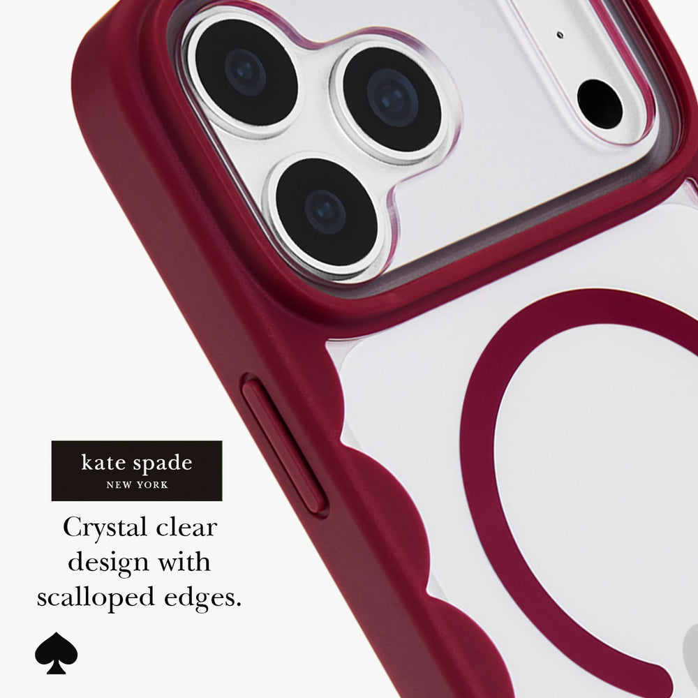 Kate Spade New York crystal clear phone case with a deep burgundy red scalloped bumper edge, shown fitted on a smartphone. The text on the image reads 'kate spade NEW YORK Crystal clear design with scalloped edges.
#color_scallop cherry glaze
