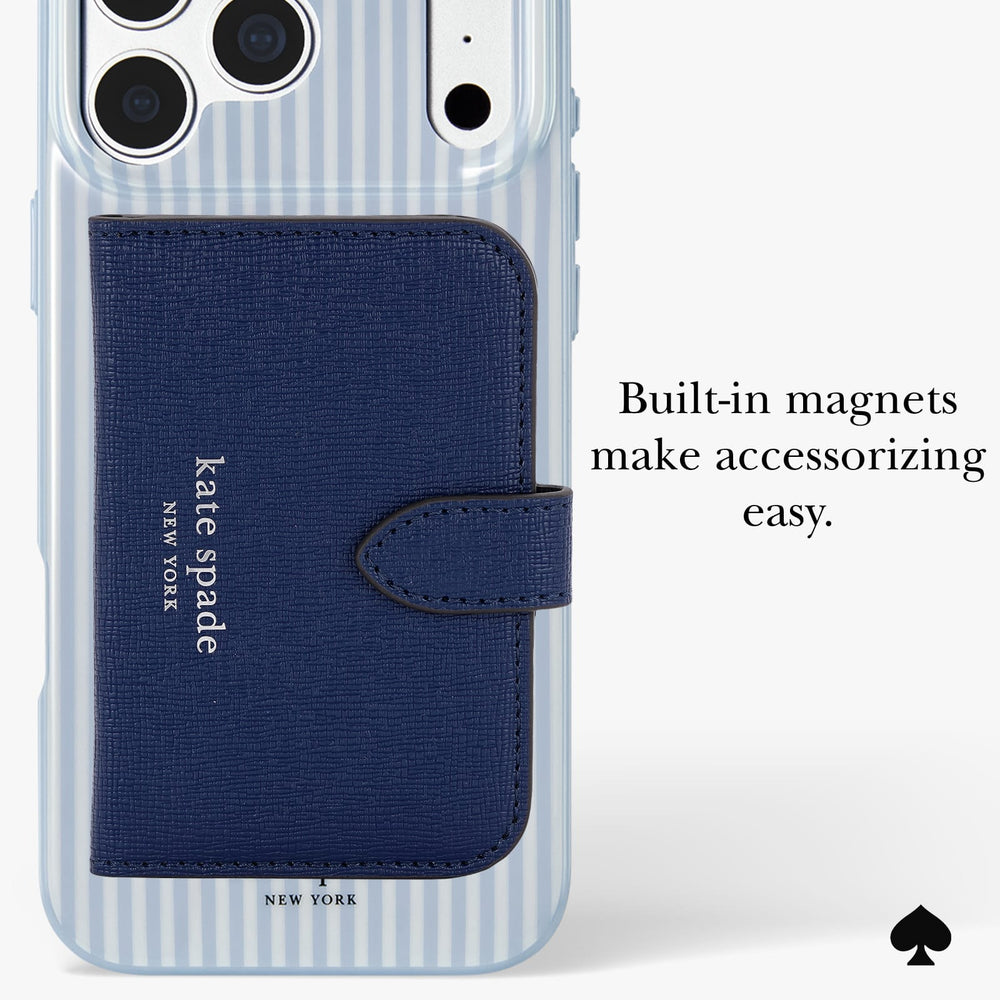 A clear phone case with light blue and white vertical stripes, featuring a dark blue textured wallet-style card holder with the Kate Spade New York logo. The image includes text that reads 'Built-in magnets make accessorizing easy.
#color_diamond blue stripe