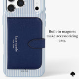 A clear phone case with light blue and white vertical stripes, featuring a dark blue textured wallet-style card holder with the Kate Spade New York logo. The image includes text that reads 'Built-in magnets make accessorizing easy.
#color_diamond blue stripe