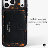 Kate Spade New York phone case with a built-in black leather card holder and white text logo, featuring a tortoiseshell pattern around the edges and camera cutout, with text on the right reading 'Built-in magnets make accessorizing easy.'.
#color_tortoise
