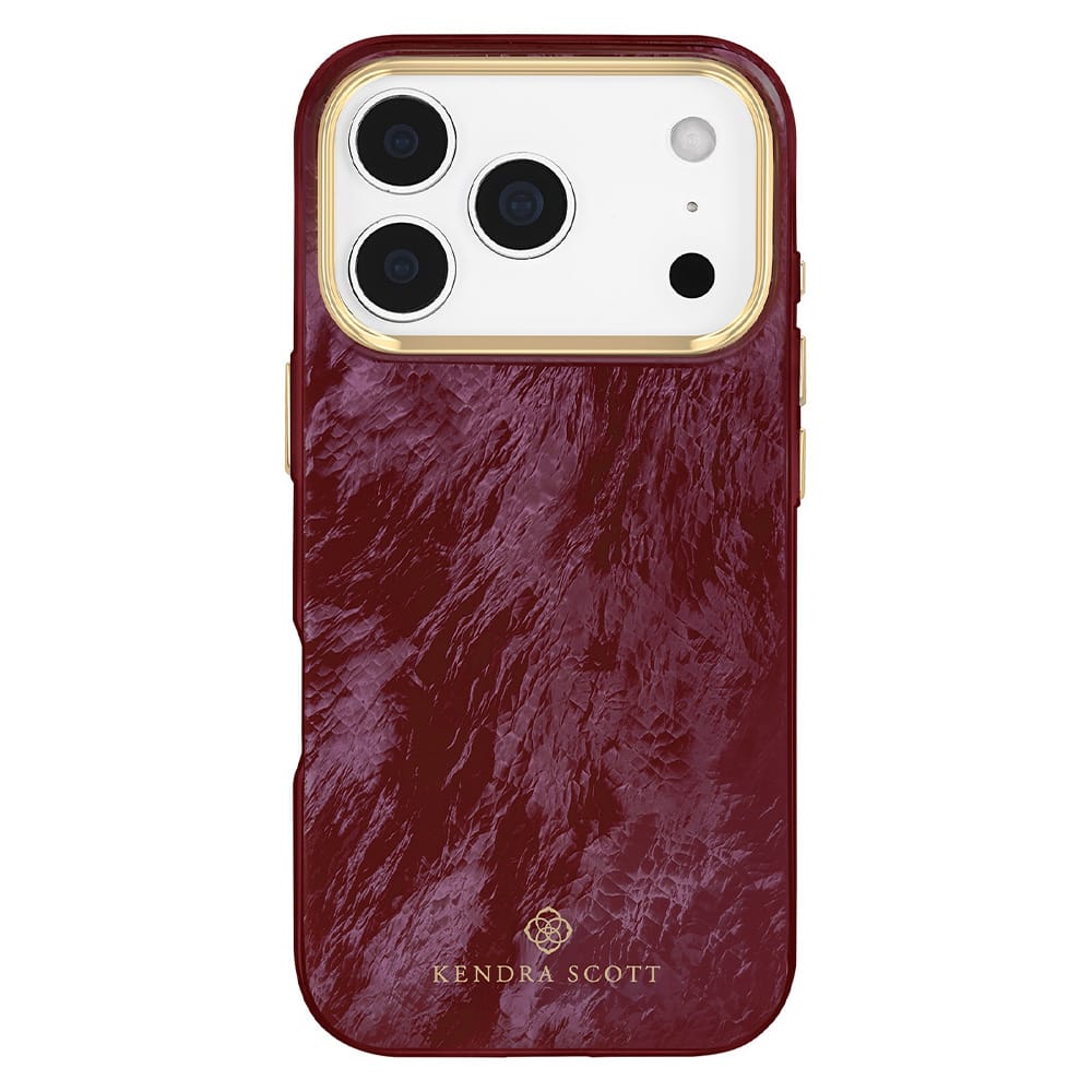 A Kendra Scott phone case in a textured deep burgundy leather finish with gold trim around the camera cutout and a gold logo at the bottom, shown on a white background.
#color_cherry lacquer pearl