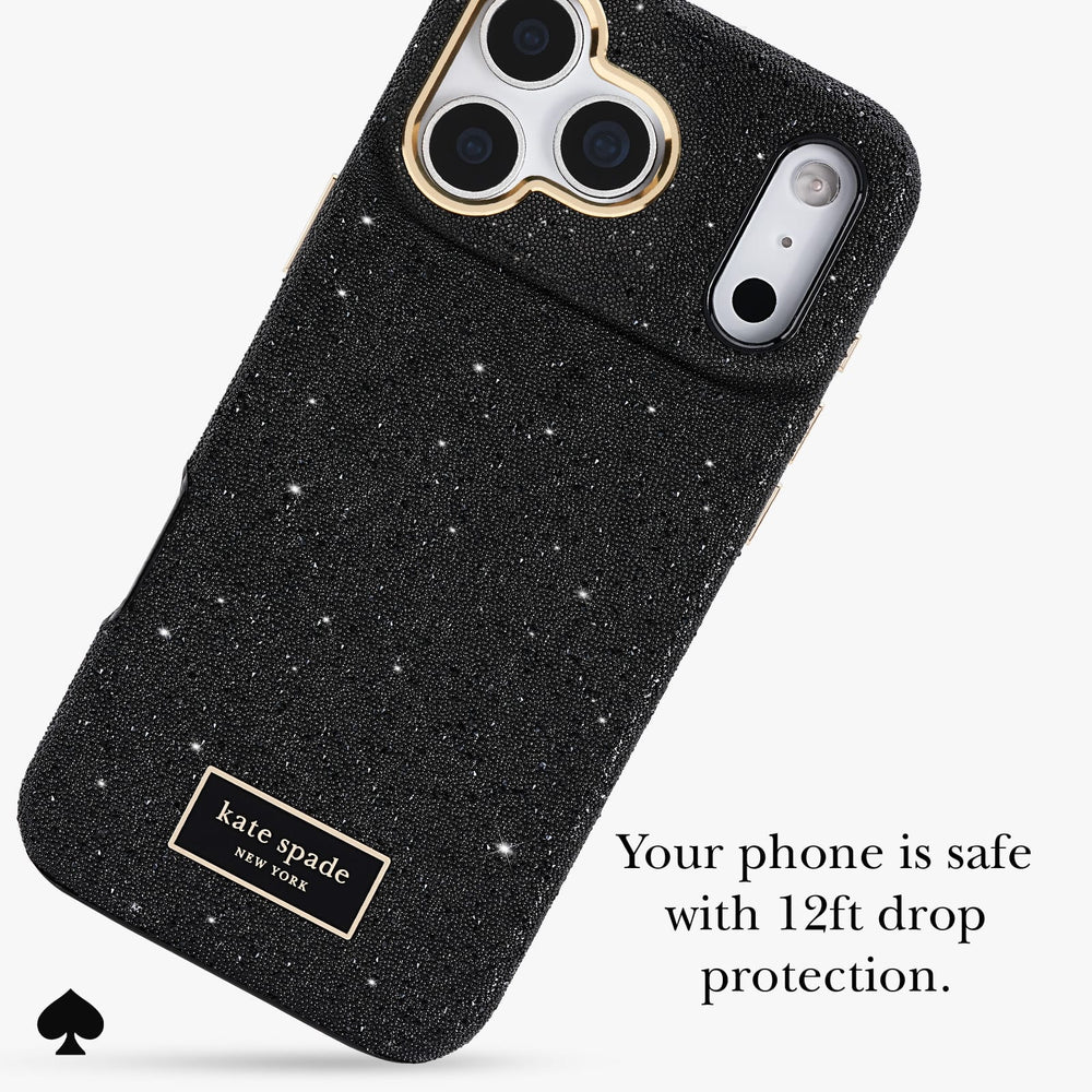 Kate Spade New York black glitter phone case with gold trim around the camera cutouts and a gold brand patch, shown on a light gray background with promotional text.
#color_crystal pavé