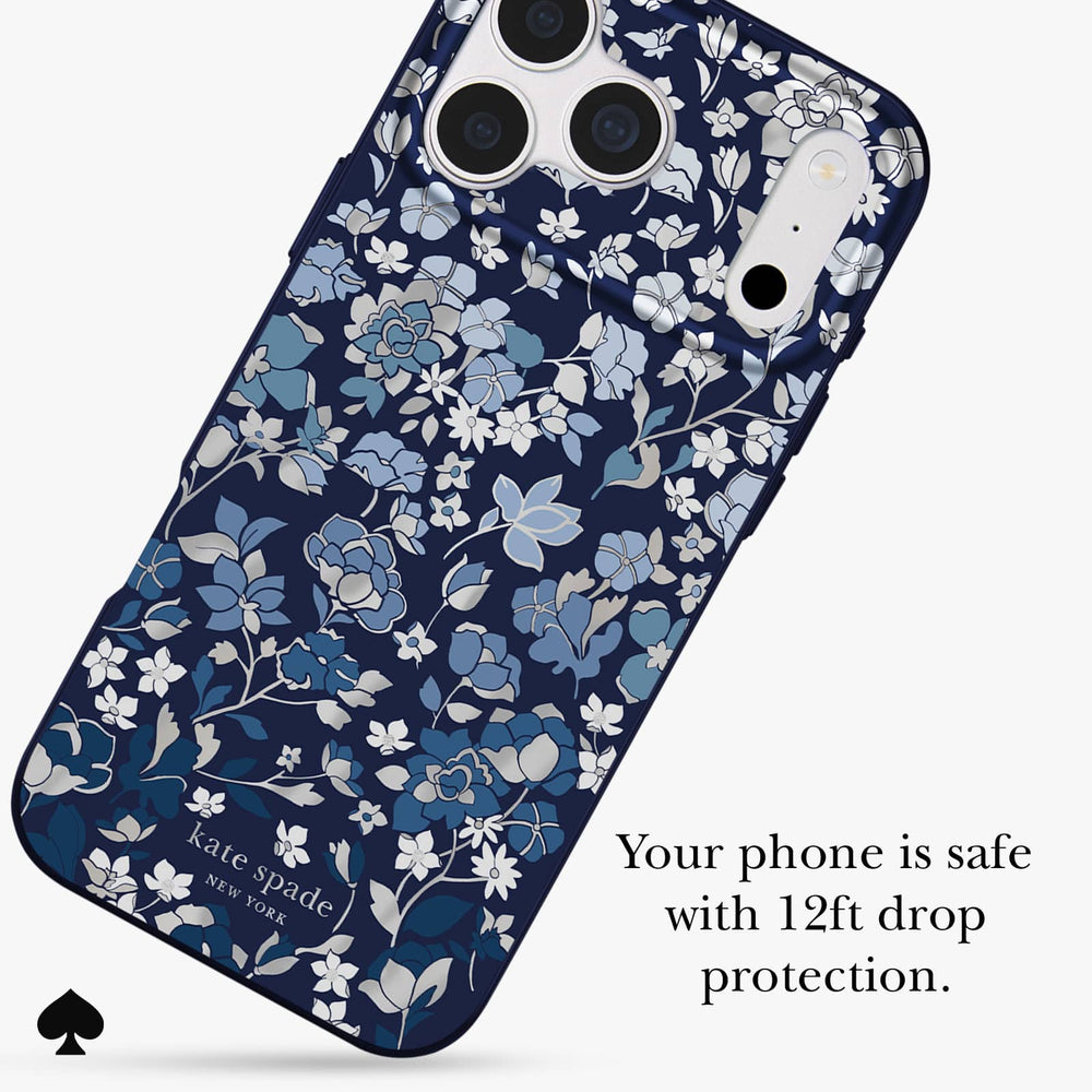 Kate Spade phone case with a navy blue background and a delicate white and light blue floral pattern, shown on a phone mockup with text stating 'Your phone is safe with 12ft drop protection.'.
#color_flowerbed navy
