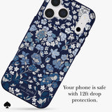 Kate Spade phone case with a navy blue background and a delicate white and light blue floral pattern, shown on a phone mockup with text stating 'Your phone is safe with 12ft drop protection.'.
#color_flowerbed navy
