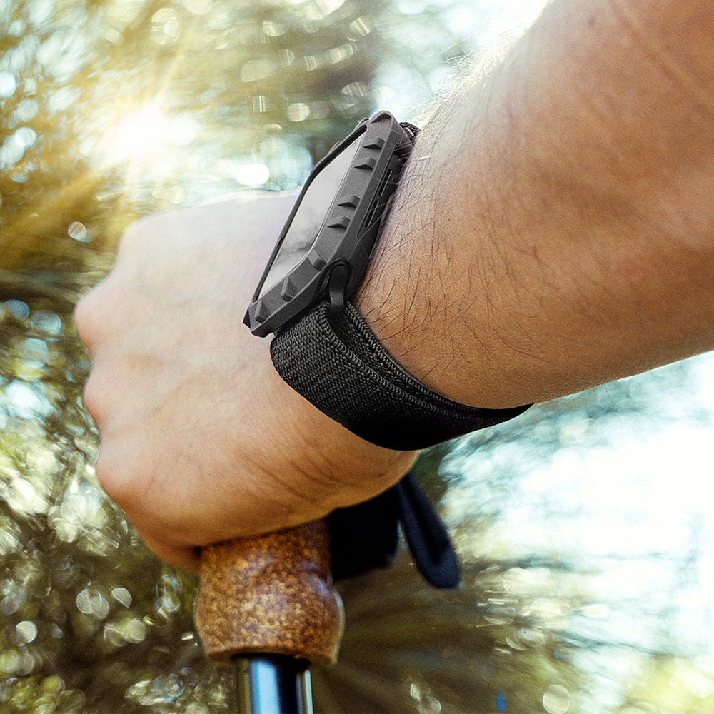 Black protective band with textured rubber bumper guard on Apple Watch worn on wrist.