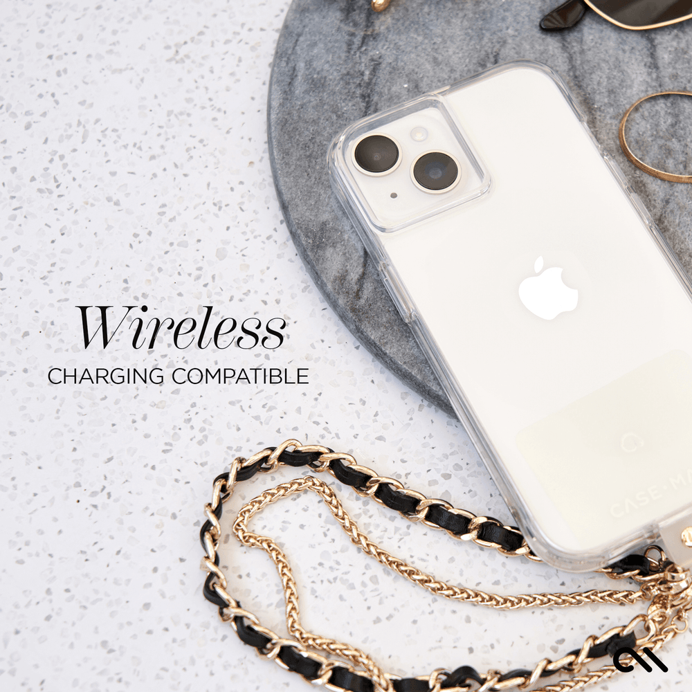 Clear iPhone 15 case with dual camera cutout and attached gold chain strap on marble surface.