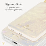 A close-up of a Kendra Scott power bank with an iridescent finish and polished gold accents, shown on a white background with descriptive text calling out the opalescent finish with gold accents 
#color_ivory pearl