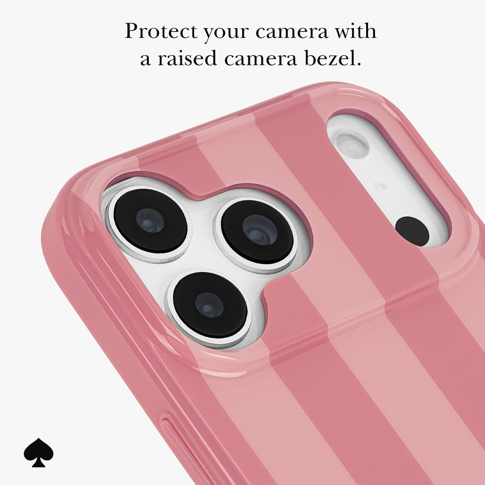 A pink striped phone case with a raised camera bezel, shown on a white background with promotional text at the top and a small black spade logo at the bottom left.

#color_stripe rose coral