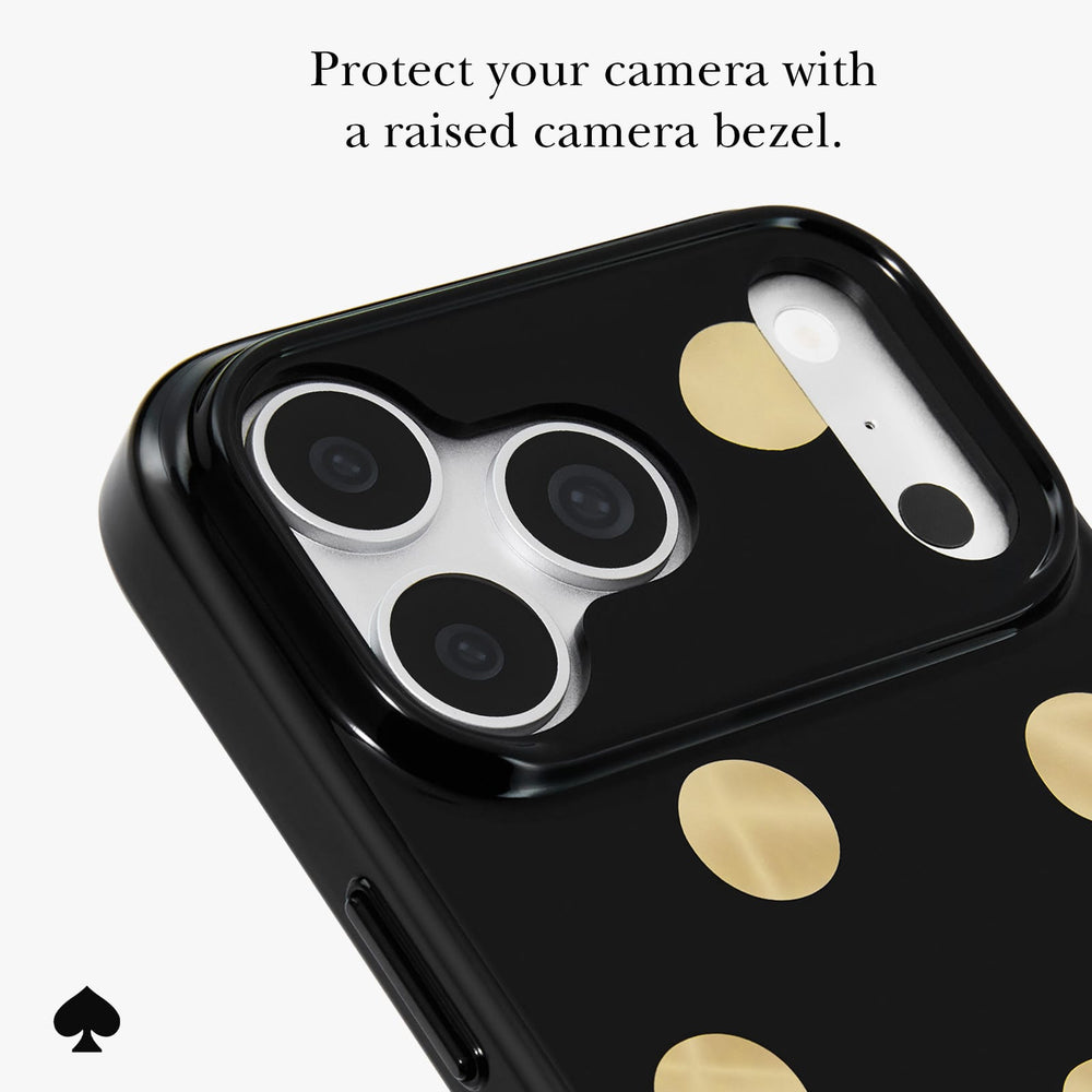 A close-up of a black phone case with gold polka dots and a raised camera bezel, shown on a light gray background with text explaining camera protection.

#color_metallic classic dot