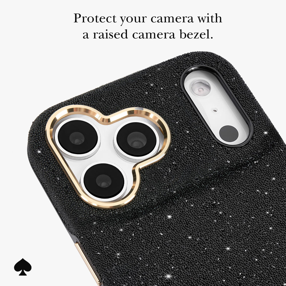 Black textured phone case with a gold heart-shaped camera bezel, shown on a light gray background with promotional text and a spade logo.
#color_crystal pavé
