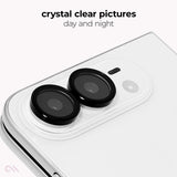 A close-up of a white smartphone showing two black circular lens protectors installed over the rear camera lenses. Text at the top reads 'crystal clear pictures day and night' on a clean white background.