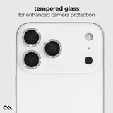 A close-up of a white smartphone showing the rear camera area with three camera lenses and a flash, overlaid with the text 'tempered glass for enhanced camera protection.' The product appears to be a phone accessory or phone-related promotional image rather than a standalone chart or instruction sheet.

#color_twinkle
