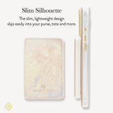 A slim rectangular Kendra Scott power bank with a soft marbled blush and cream finish, shown alongside a side profile view on a light gray background with descriptive text.

#color_ivory pearl