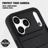 Black textured phone case with a raised camera bezel, shown close-up on a light textured background with text reading 'PROTECT YOUR CAMERA WITH 1.6MM RAISED CAMERA BEZEL' and a Pelican badge.
#color_protector black