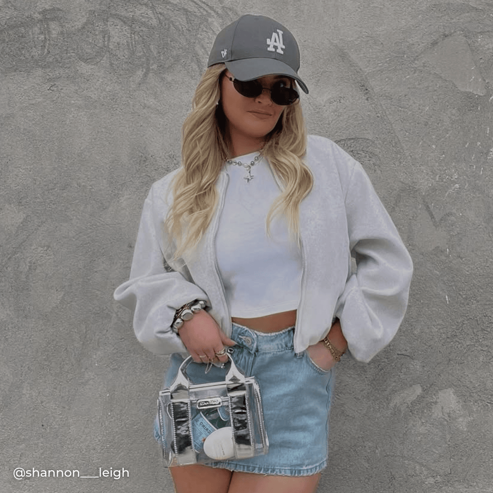 Woman holding a clear stadium bag posing for a picture
#color_silver chrome