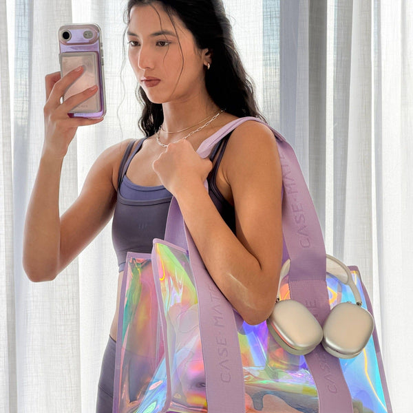 Woman holding a colorful bag with CASEMATE branding in front of a white curtain.
#color_iridescent