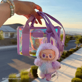 Woman holding clear stadium bag with toy hanging from it
#color_soap bubble®