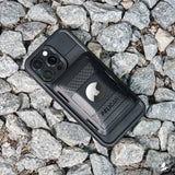 Black Pelican MagSafe wallet case for iPhone with quad camera cutout and white Apple logo visible on back.