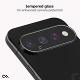 A close-up of a black smartphone showing the back camera area with a clear, rounded rectangular tempered glass protector installed over the lenses. Text at the top reads 'tempered glass for enhanced camera protection' on a light gray background.