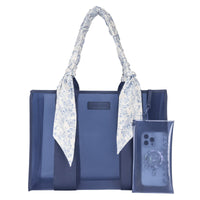 Blue tote bag with floral handle and matching phone case on a white background
#color_something navy twilly