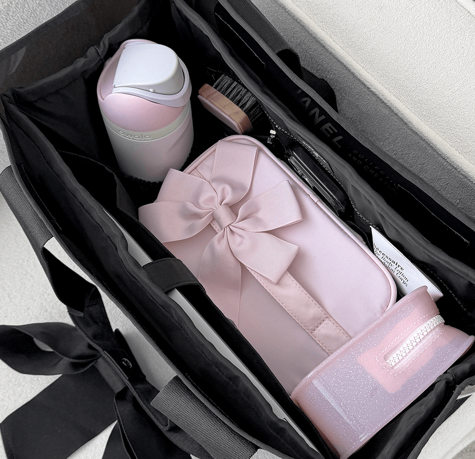 The jelly tote resting on a carry-on suitcase