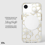 A clear phone case with a white and gold floral pattern, shown on a phone with MagSafe magnets attached. The image includes text on the left reading 'STRONG BUILT-IN MAGNETS FOR MagSafe CHARGING AND ACCESSORIZING' and a Case Mate logo at the bottom.