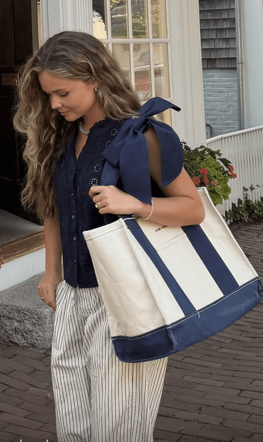 Customer carrying the navy and canvas tote