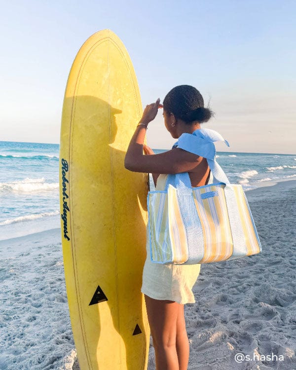 Girl on beach with yellow surfboard and cabana stripe bow jelly tote bag