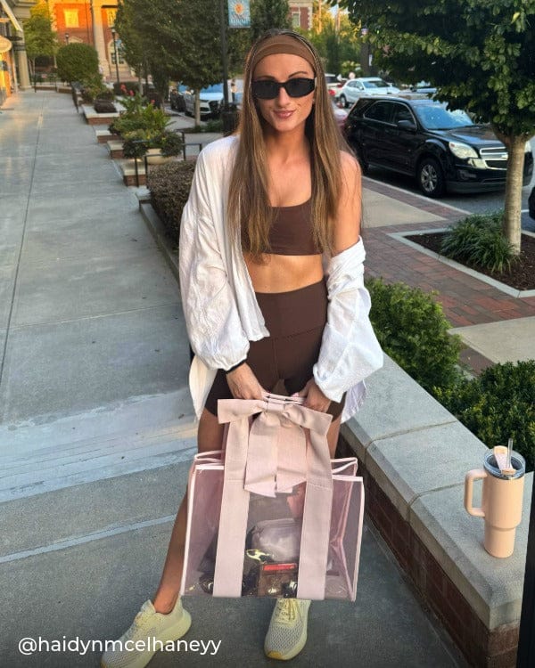Girl standing outside in gym outfit with Ballet Pink Jelly Tote Bag