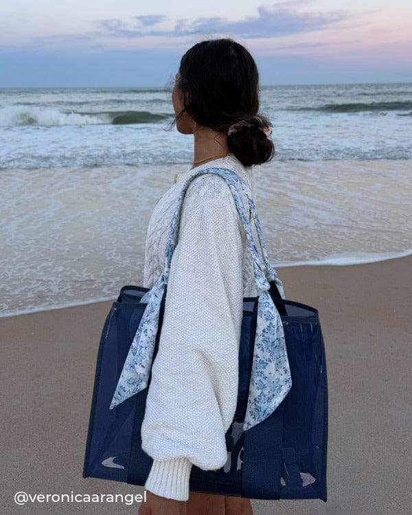 Girl looking towards the ocean with a white sweater and Something Navy Twilly Jelly Tote