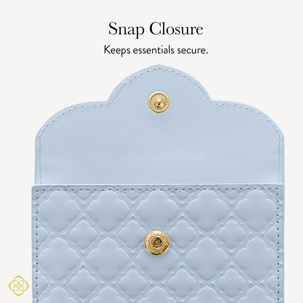 Light blue quilted wallet with gold snap closure on a white background #color_blue filigree