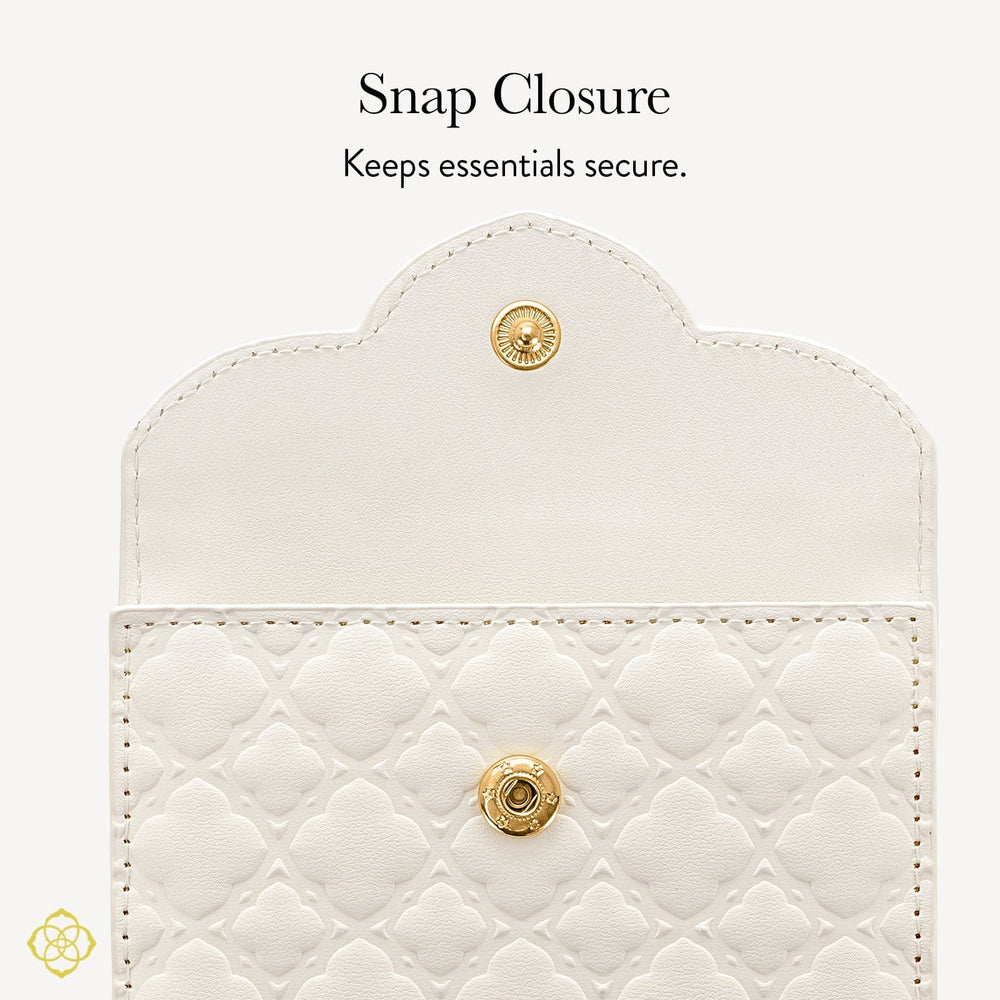 White quilted wallet with gold snap closure on a light gray background

#color_Ivory Filigree