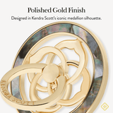 A polished gold medallion keychain with a layered abalone shell inlay, shown on a light gray background with promotional text reading 'Polished Gold Finish' and 'Designed in Kendra Scott's iconic medallion silhouette.'.
#color_black mother of pearl