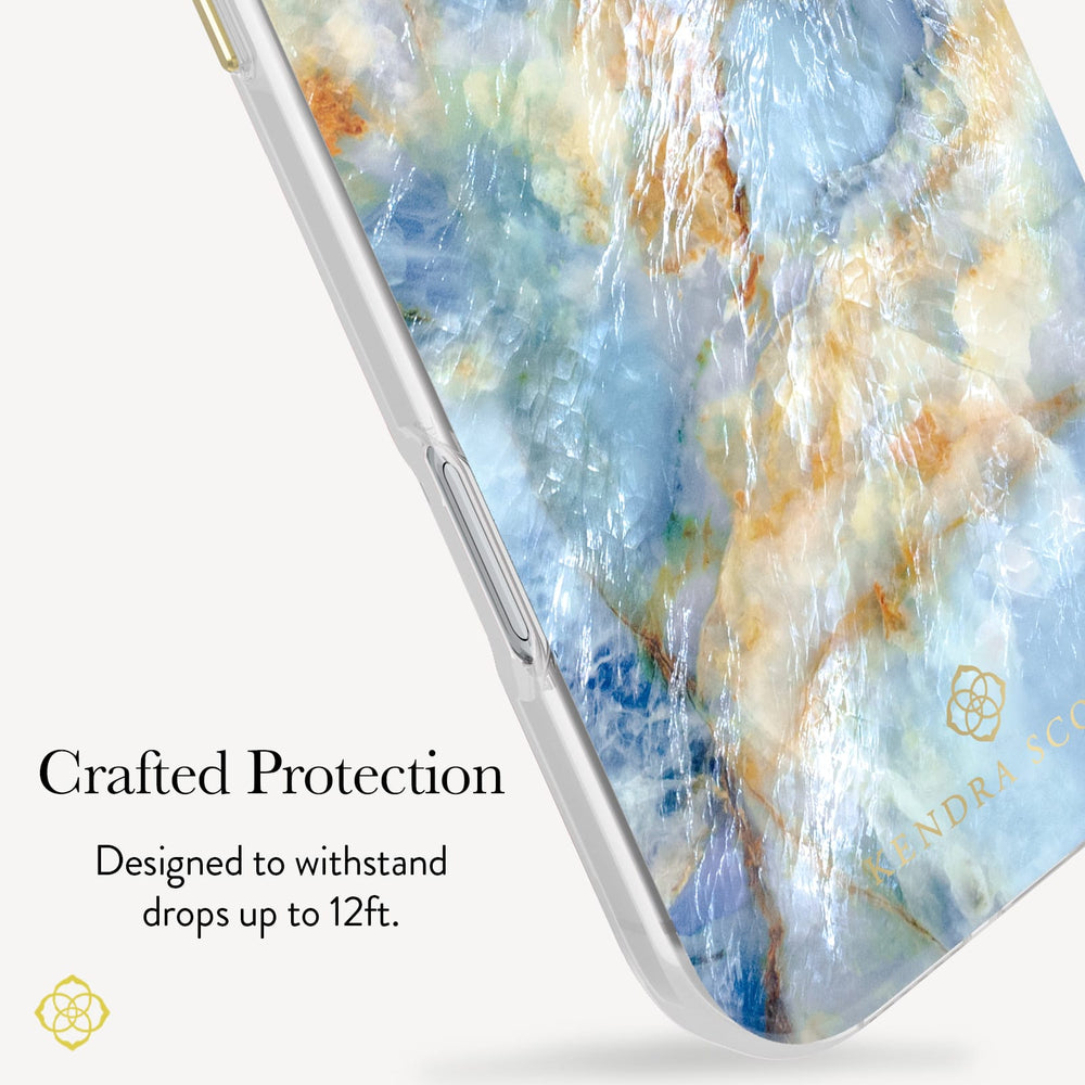 A close-up of a smartphone case with a marbled blue, cream, and gold pattern, shown on a phone edge against a light gray background with marketing text that reads 'Crafted Protection' and 'Designed to withstand drops up to 12ft.'.