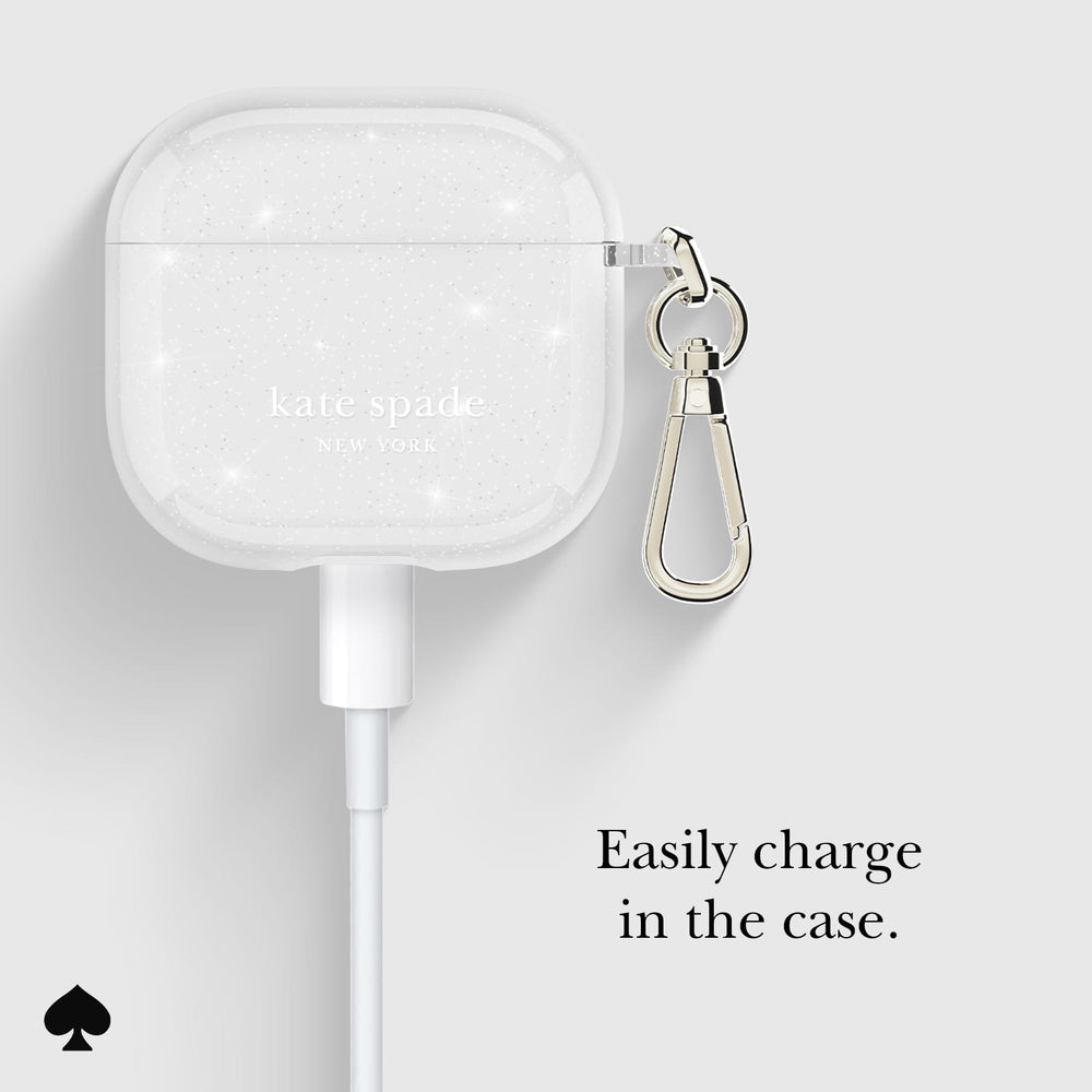 Kate Spade wireless earbuds case with keychain on a light gray background