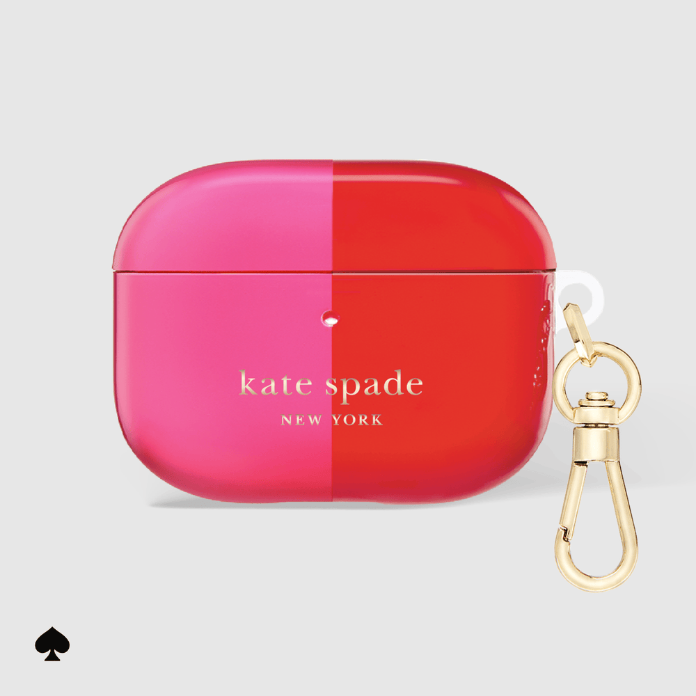 Kate Spade New York AirPods case in a vibrant pink and red split design, featuring a gold-tone clasp keychain on a light gray background.