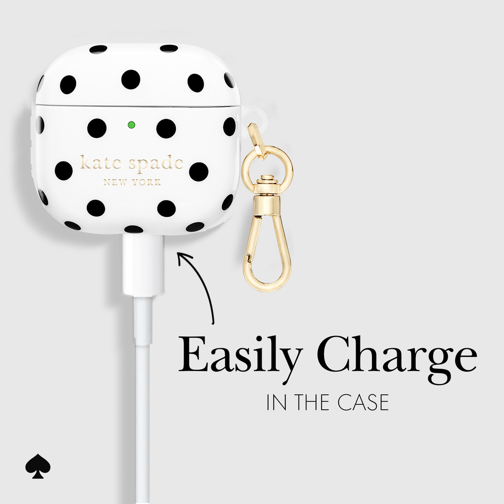 White AirPods case cover with black polka dots and gold 'kate spade NEW YORK' branding, shown with a gold clasp accessory on a light gray background with the text 'Easily Charge IN THE CASE'.