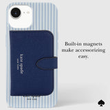 Kate Spade New York phone case with a navy blue built-in wallet magnet and strap, shown on a light gray background with text that reads 'Built-in magnets make accessorizing easy.'.
