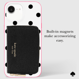 Kate Spade New York black textured wallet with gold logo, shown attached to a white phone case with black polka dots and a pink border. Text on the right reads 'Built-in magnets make accessorizing easy.