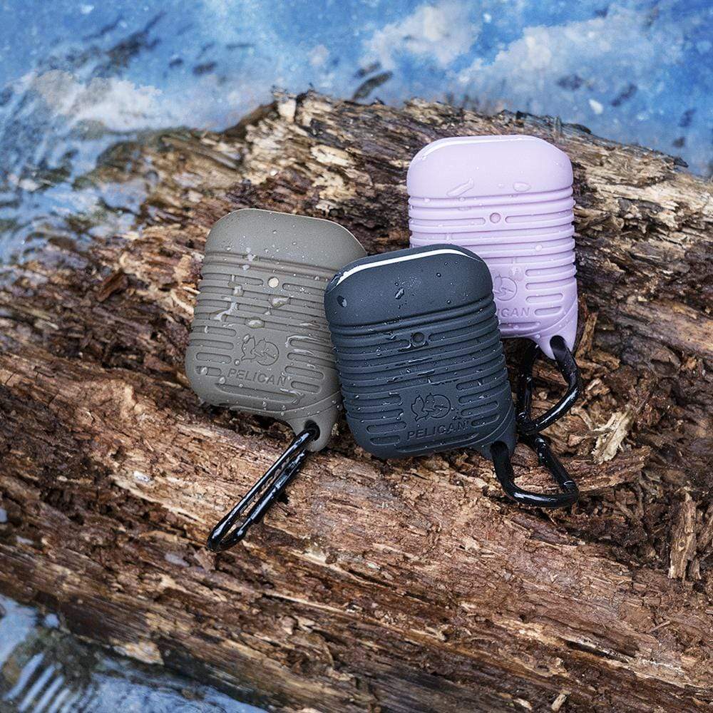 Pelican Protector AirPods cases sitting on a wet log. color::Olive Green