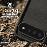A rugged black Pelican phone case shown close-up outdoors on rocky ground, with text reading '24FT [6X] MILITARY GRADE DROP PROTECTION' and Pelican branding.