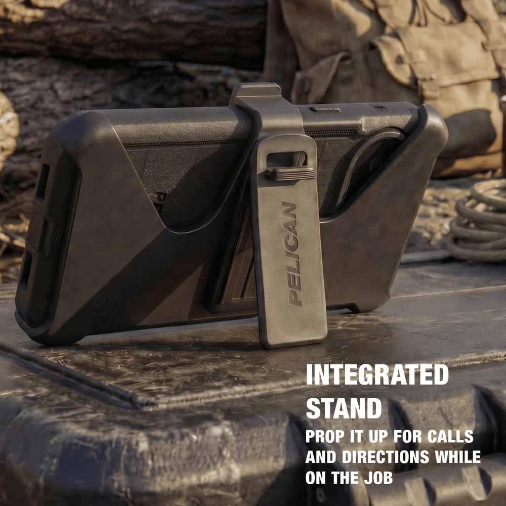 A rugged black Pelican phone case with an integrated metal stand, shown outdoors on a textured surface with a coiled rope and log in the background. White text on the bottom right reads 'INTEGRATED STAND' and 'PROP IT UP FOR CALLS AND DIRECTIONS WHILE ON THE JOB'.