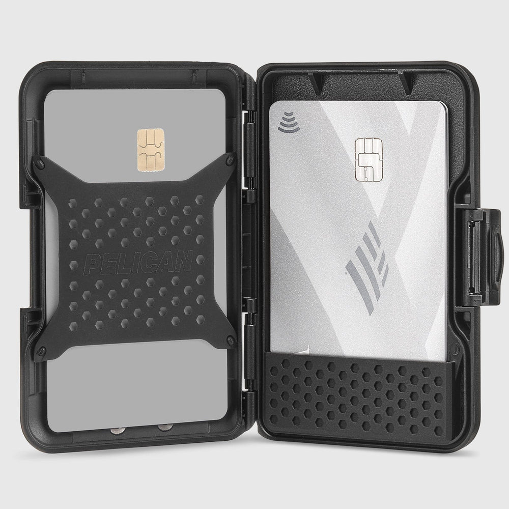 Black dual-slot card holder with textured grip panels holding a gold chip card and white contactless card.