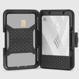 Black dual-slot card holder with textured grip panels holding a gold chip card and white contactless card.