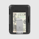 Black money clip wallet with rounded corners holding a twenty dollar bill and metal card slot visible on front.