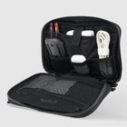 Black tech organizer with multiple compartments holding mouse, cables, earbuds, and pens.