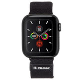Black woven Apple Watch band with Pelican logo, displayed on smartwatch with black case and activity rings dial.