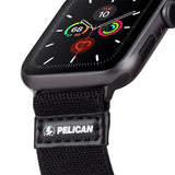 Apple Watch with gray protective case and black fabric band with Pelican logo and leather accent.